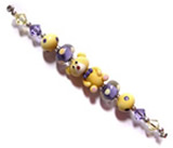 thomas the teddy lampwork bead set in purple and opal yellow glass